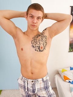 Tattooed guy likes to strip down before playing with his pecker on the bed