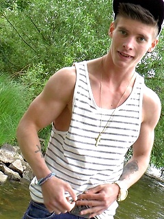 Young jock with a six pack smiles and flashes those hot abs for us outdoors