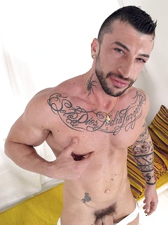 Bearded and tattooed solo hunk Sergio has fun getting naked and jerking off